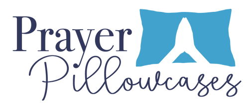 Prayer Pillowcases logo with folded hands over blue pillow