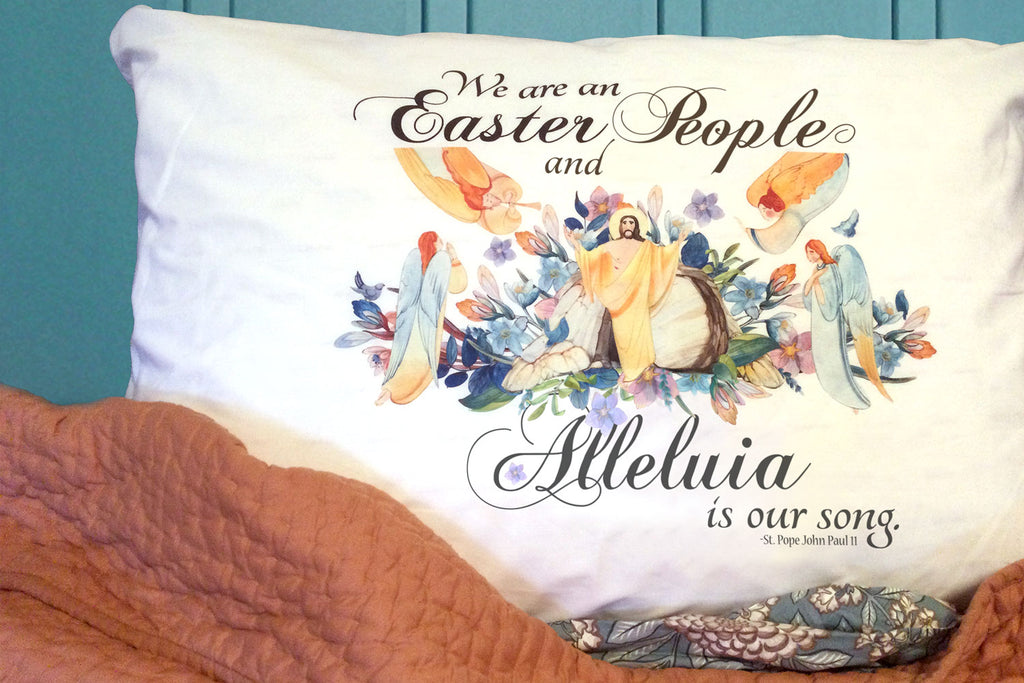 Our beautiful Easter pillowcase features Pope JPII's uplifting "Easter People" quote pictured with Christ risen and attended by angels in a heavenly garden.