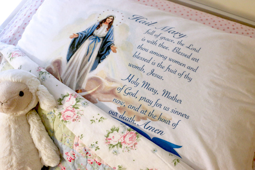 Our Lady of Grace Hail Mary Prayer Pillowcase features a beautiful devotional image of Mary with the Hail Mary prayer to unite a prayerful heart and a peaceful imagination. This inspirational Marian design gives Catholic of all ages a gentle reminder to begin and end each day with a hearts turned to heaven.